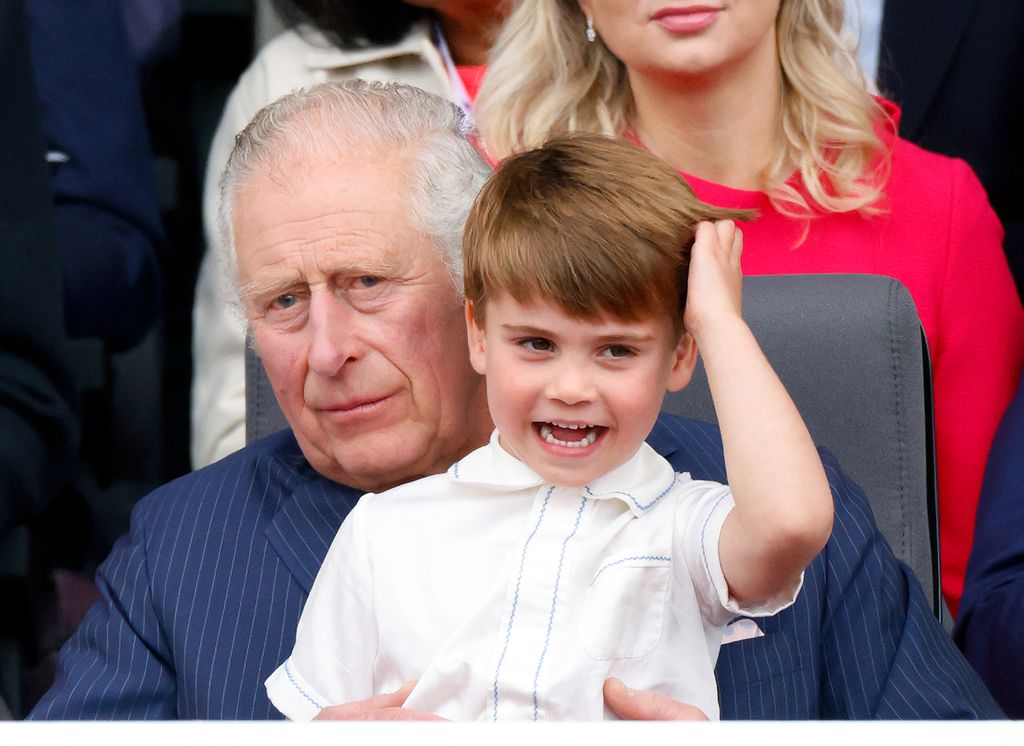 King Charles with Prince Louis sat on his lap