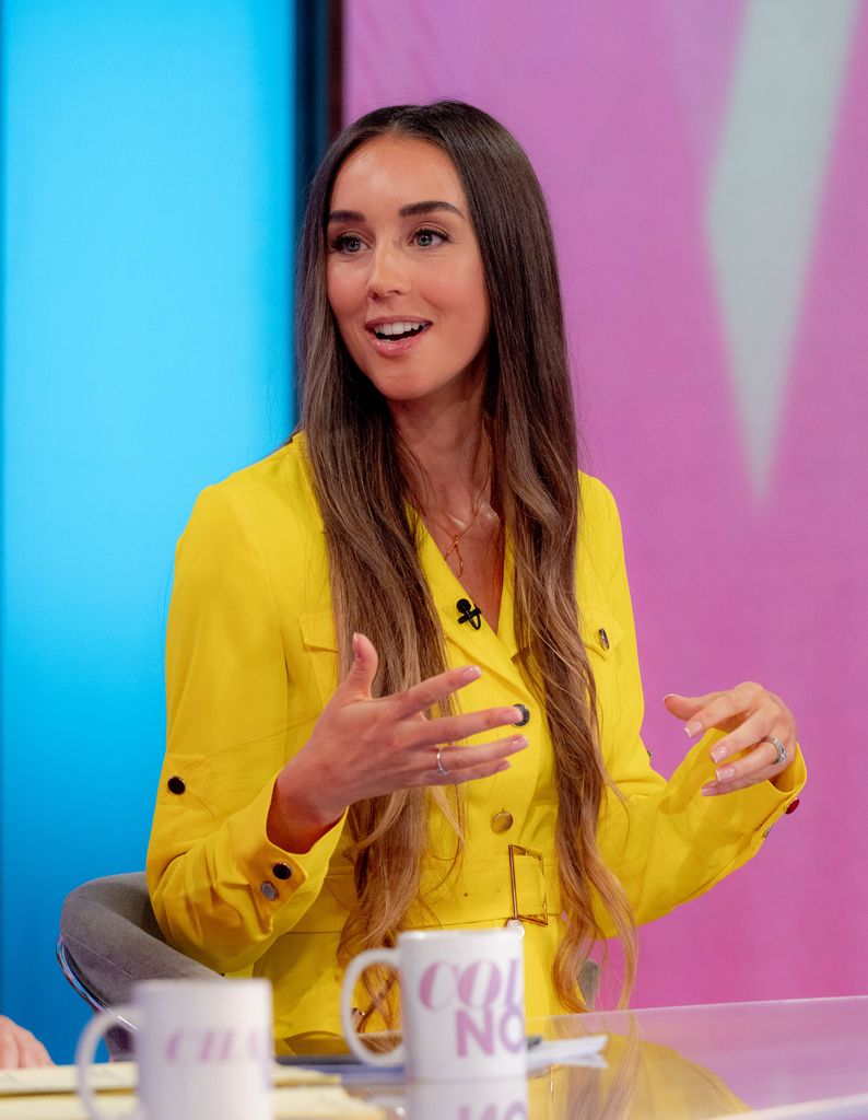 Emily Andre in a yellow belted dress on Loose Women