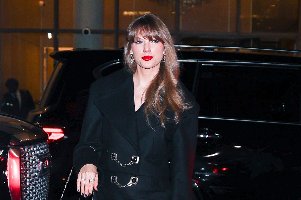 Taylor Swift arriving at Nobu Downtown in New York with her red lipstick on, but of course