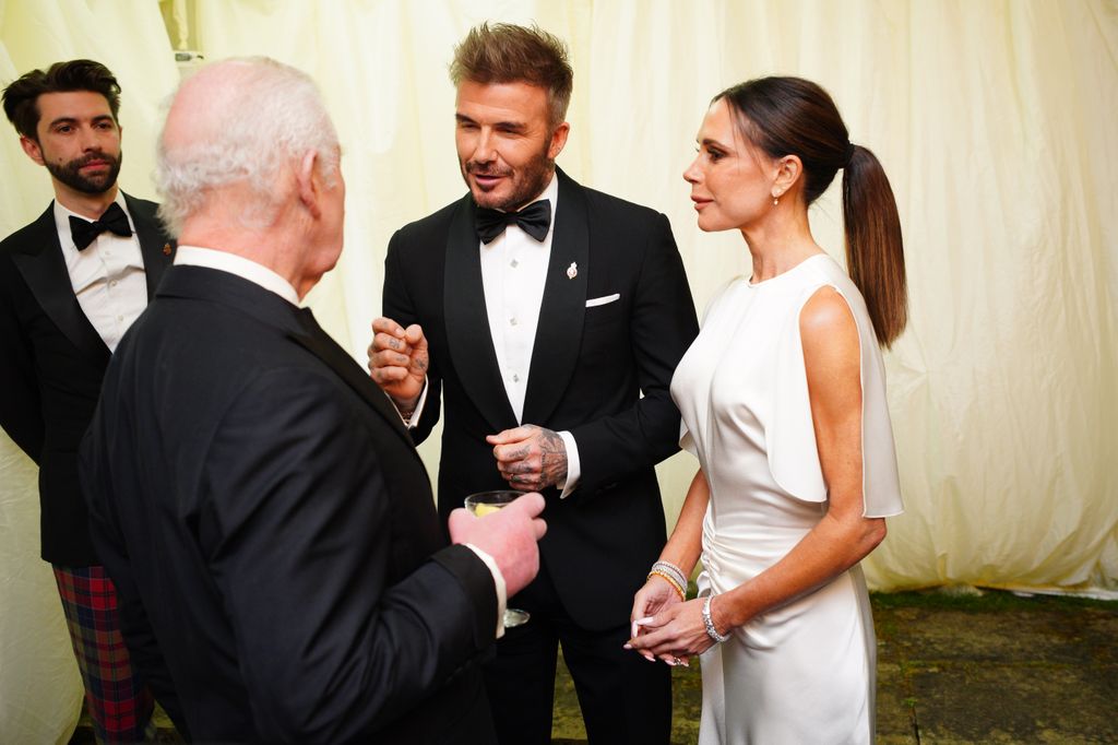 King Charles III speaks to David Beckham and Victoria Beckham during a dinner in celebration of Slow Food at King Charles III's Gloucestershire estate, Highgrove Gardens on February 7, 2025 inTetbury, England. 