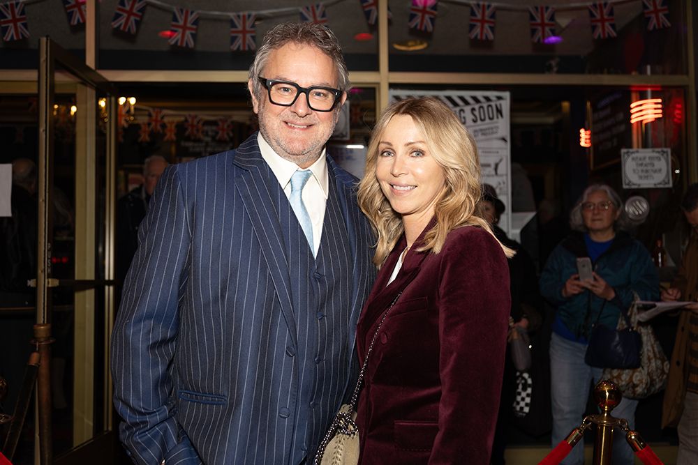 Hugh Bonneville and Heidi Kadlecova pose inside the Vogue Theatre