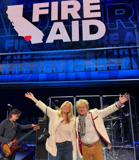 Penny Lancaster and Rod Stewart in front of a FireAid sign