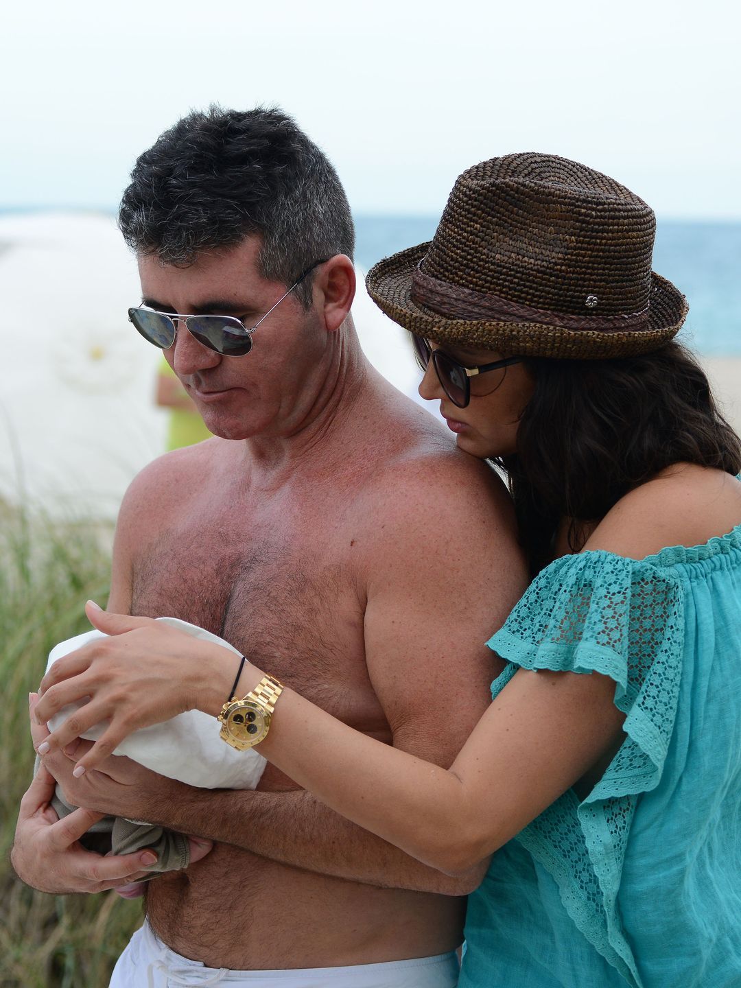 Simon Cowell and Lauren Silverman on the beach with a baby boy