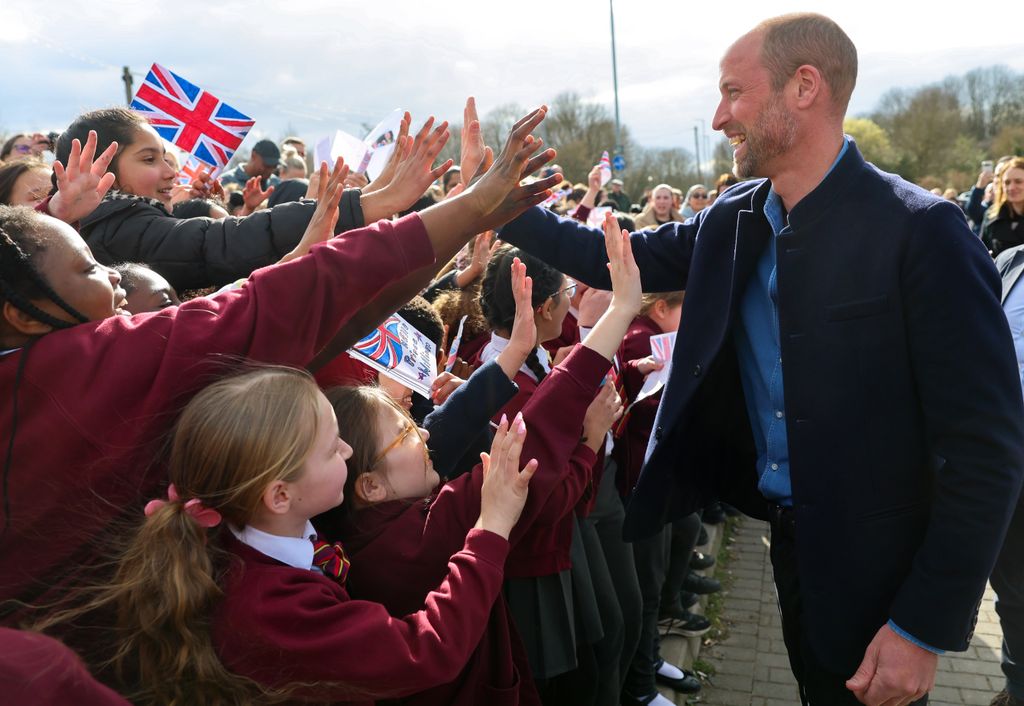 William was greeted by high-fives from schoolchildren