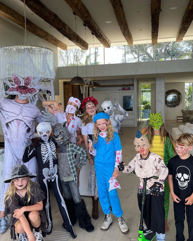 Chris Hemsworth and family posing in their living room dressed in Halloween costumes