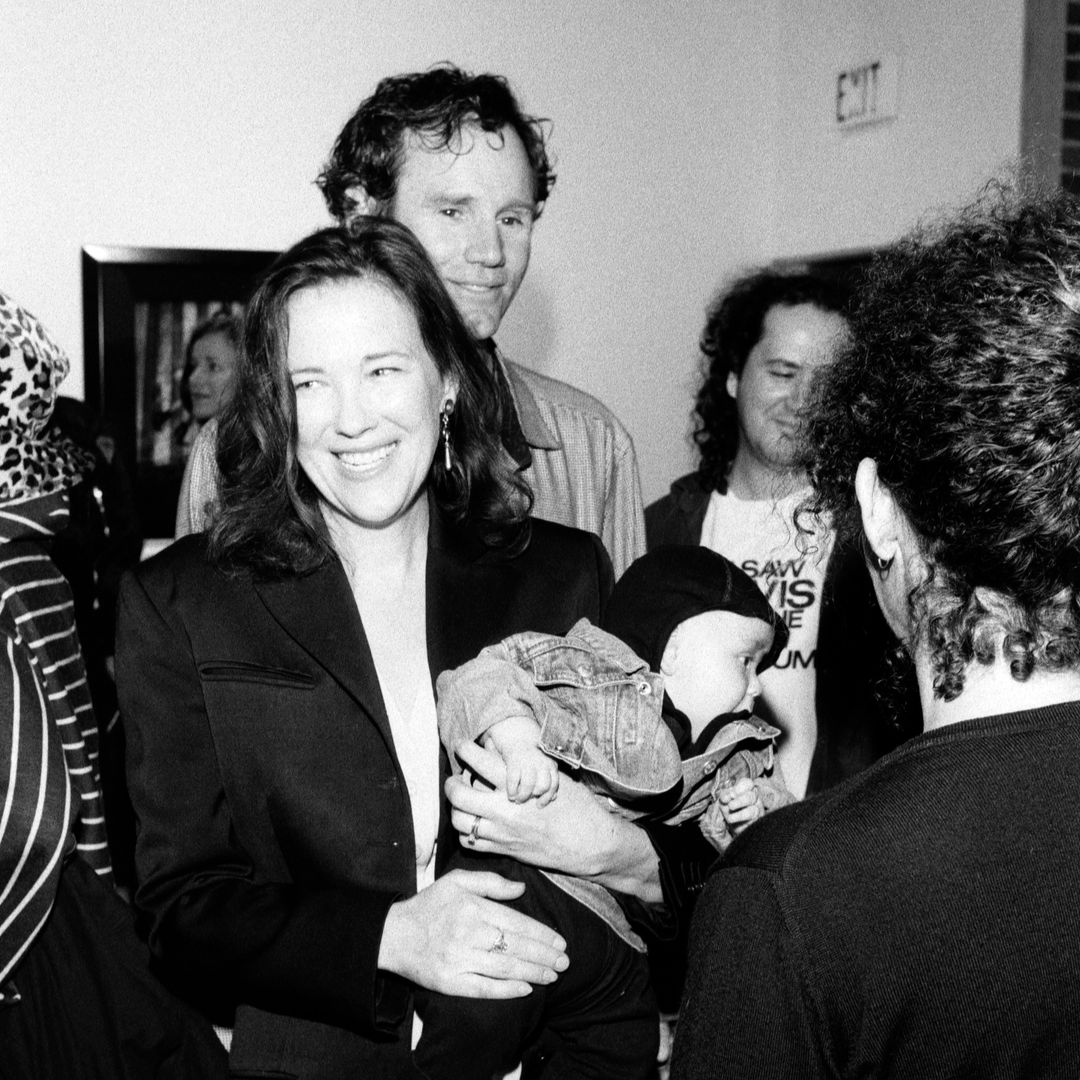 Catherine O'Hara, Matthew Welch (infant), and Bo Welch (behind O'Hara) attend an event at the Garage Gallery in West Hollywood, California, on October 29, 1994.