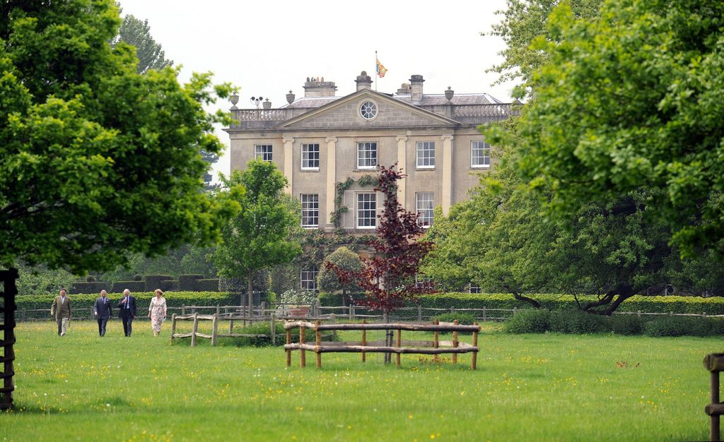 King Charles walks to plant a tree at his Highgrove home