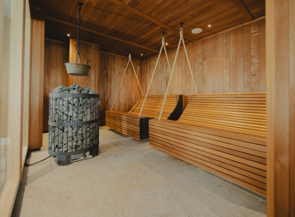 A herbal sauna room with wooden chairs