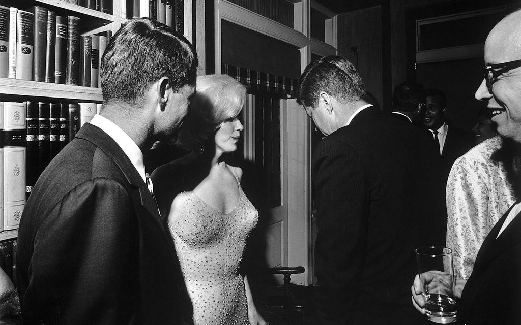 U.S. President John F Kennedy (back to camera), stands next to Marilyn Monroe and Bobby Kennedy (left)  on President Kennedy's 45th birthday celebrations in 1962