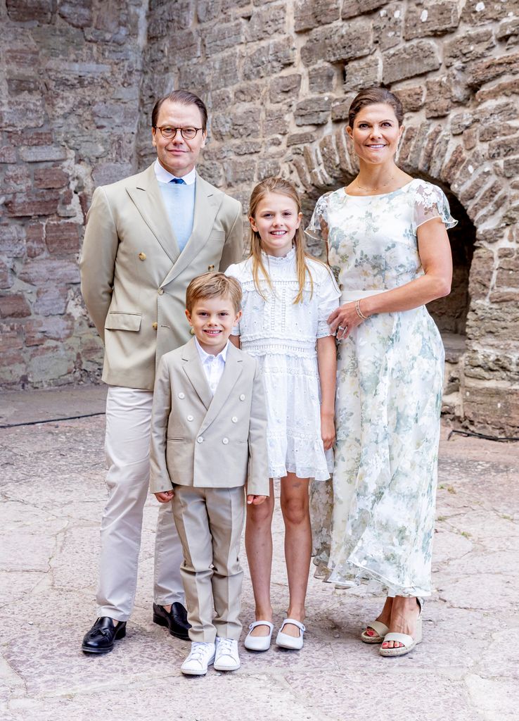 family of four posing for photo in summer