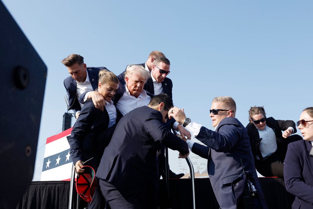 Republican presidential candidate former President Donald Trump is rushed offstage during a rally on July 13, 2024 in Butler, Pennsylvania