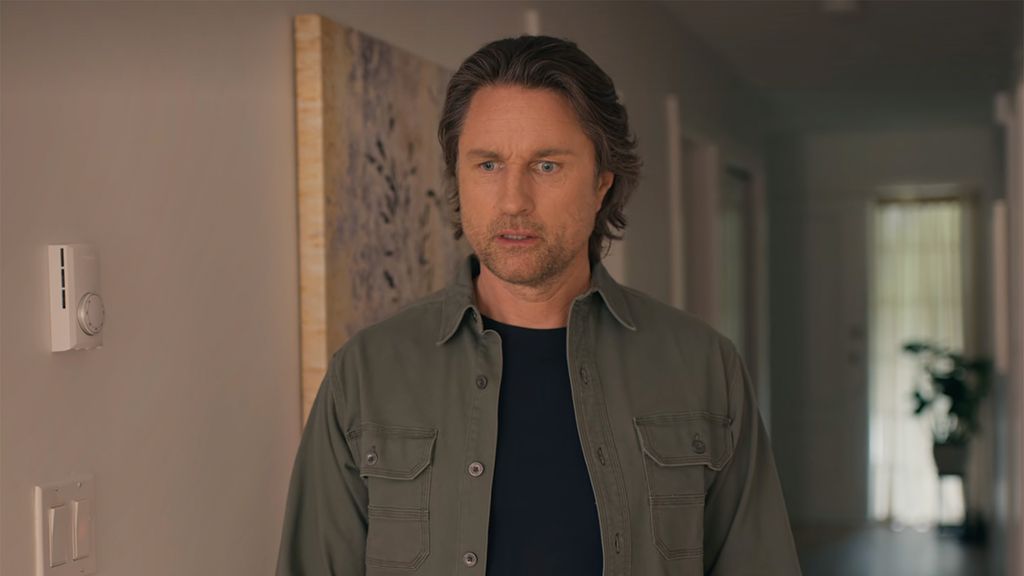 Martin Henderson as Jack Sheridan, standing in Charmaine's hallway