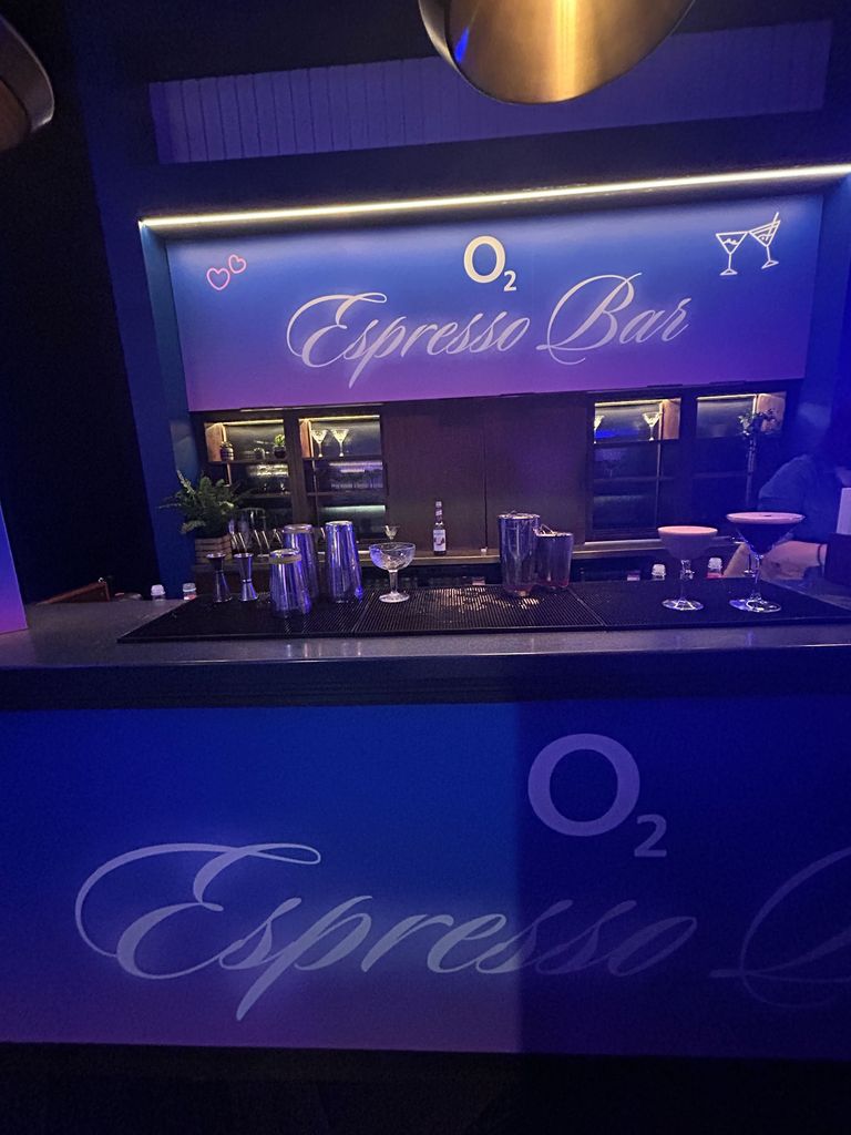 A photo of a purple bar that reads "Espresso Bar"