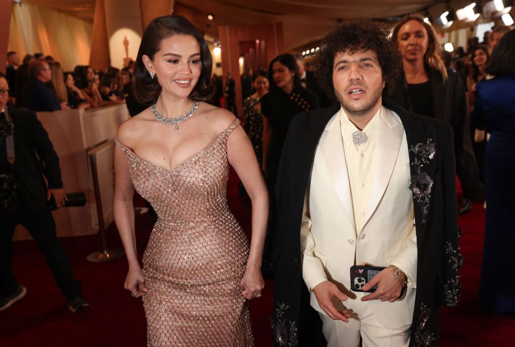 Selena Gomez and Benny Blanco walk through the press pen into the theater at the 97th Annual Academy Awards in Los Angeles, California on 02 Mar 2025