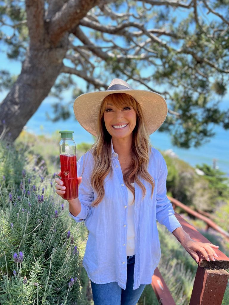 Jane smiling in malibu with drink