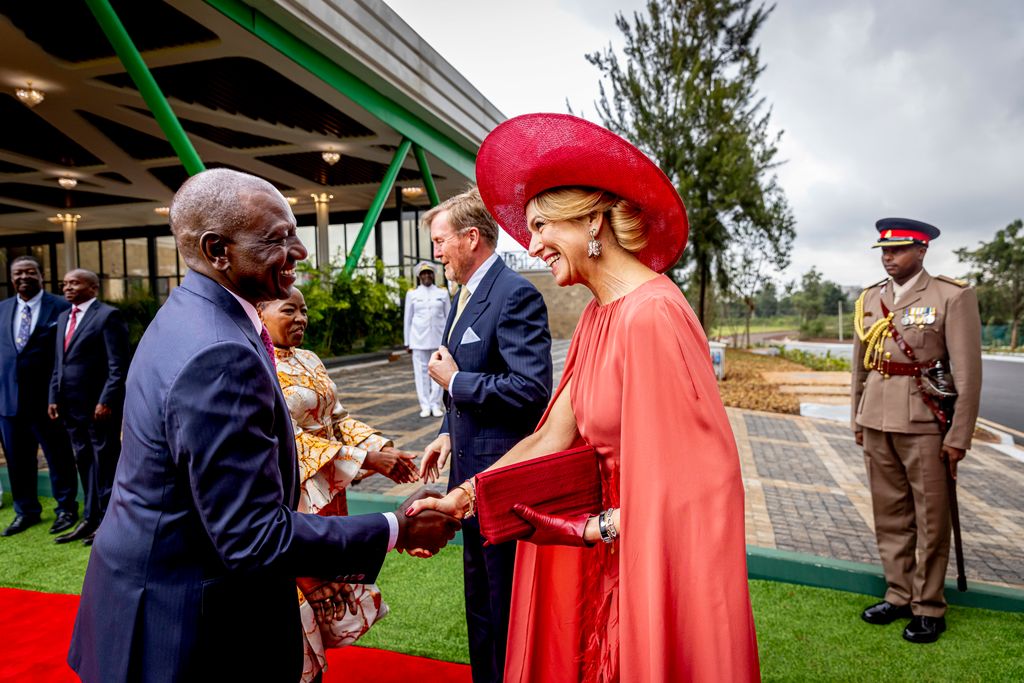 Queen Maxima of the Netherlands wears a striking red outfit and a pair of dazzling tulip drop earrings to shake the hand of Queen Maxima of the Netherlands (L) flanked by Kenyan First Lady Rachel Ruto (R), look on at media briefing by unseen King Willem-Alexander and unseen Kenya's President William Ruto at the State House in Nairobi on March 18, 2025.