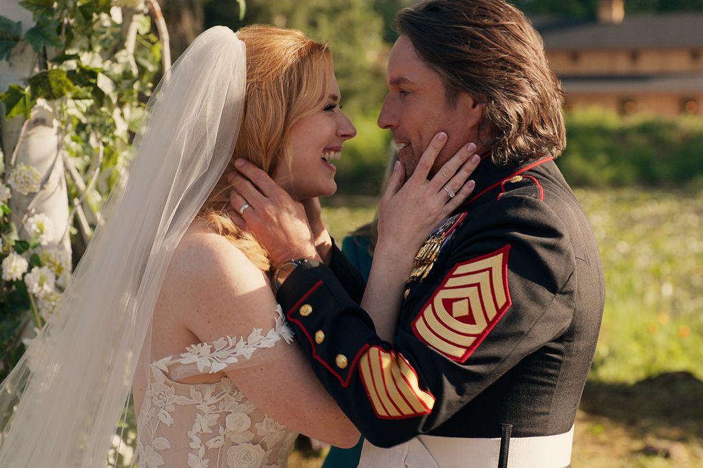 Bride and groom holding each other's faces and smiling