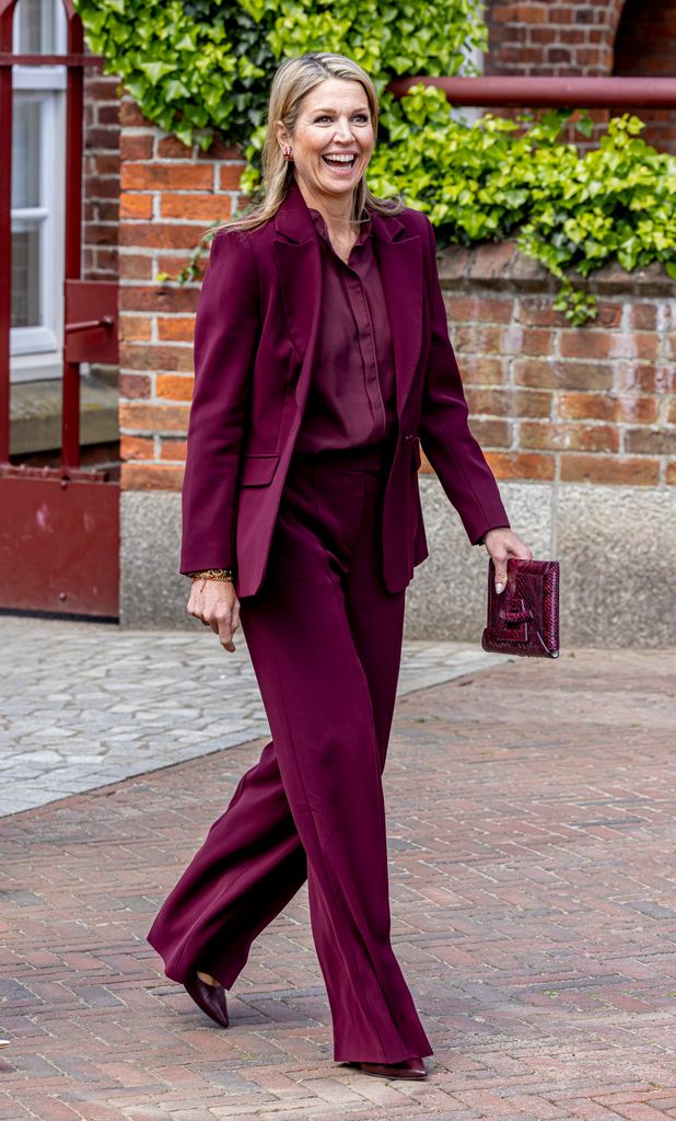 Queen Maxima in a plum red suit