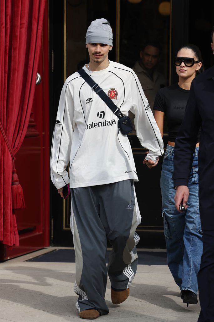 Romeo Beckham and Kim Turnbull leaving their hotel in Paris wearing casual clothes