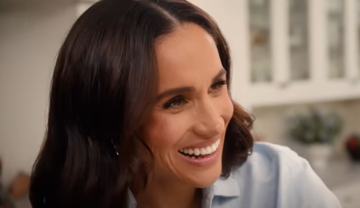 Meghan Markle wearing blue shirt and smiling in Netflix show