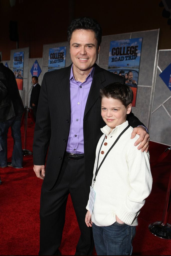 Donny Osmond with his arm around Joshua Osmond smiling at at the World Premiere of Walt Disney Pictures