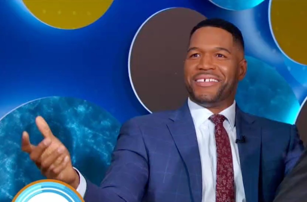 Michael Strahan on GMA set throwing hands up