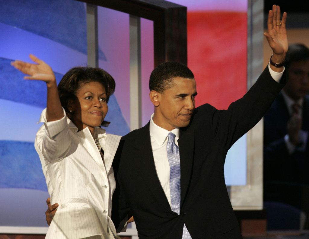 Keynote speaker Barack Obama, candidate for US Senate - Illinois, and his wife, Michelle, wave to the delegates during the DNC at the FleetCenter Tuesday, July 27, 2004.