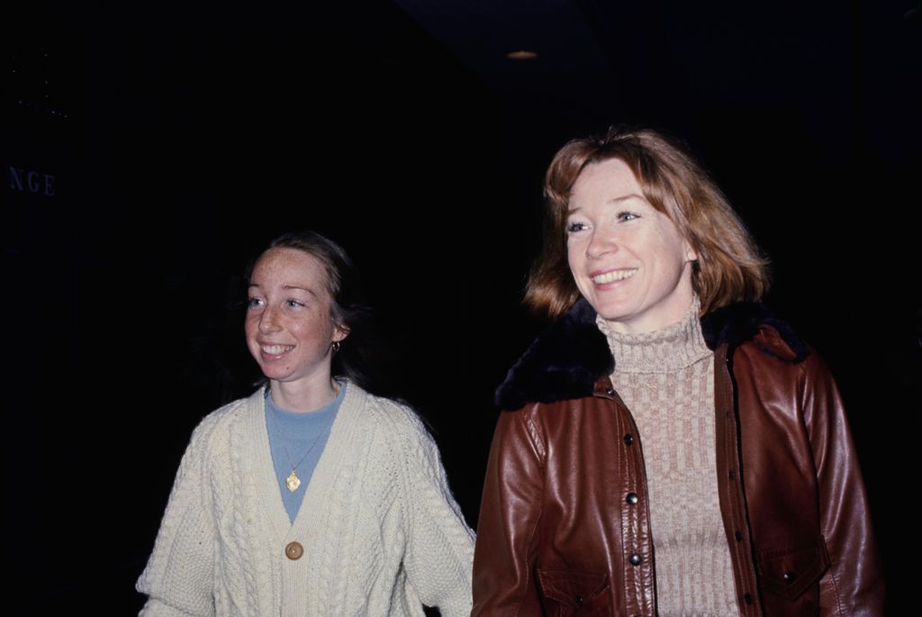 American actress Sachi Parker, wearing a white cable knit cardigan over a blue t-shirt, and her mother, American actress Shirley MacLaine, who wears a brown leather jacket with a black fur collar over a beige turtleneck sweater, attend a stage production of 'Pastorale', at the Beverly Hills Playhouse in Beverly Hills, California, 1st April 1974