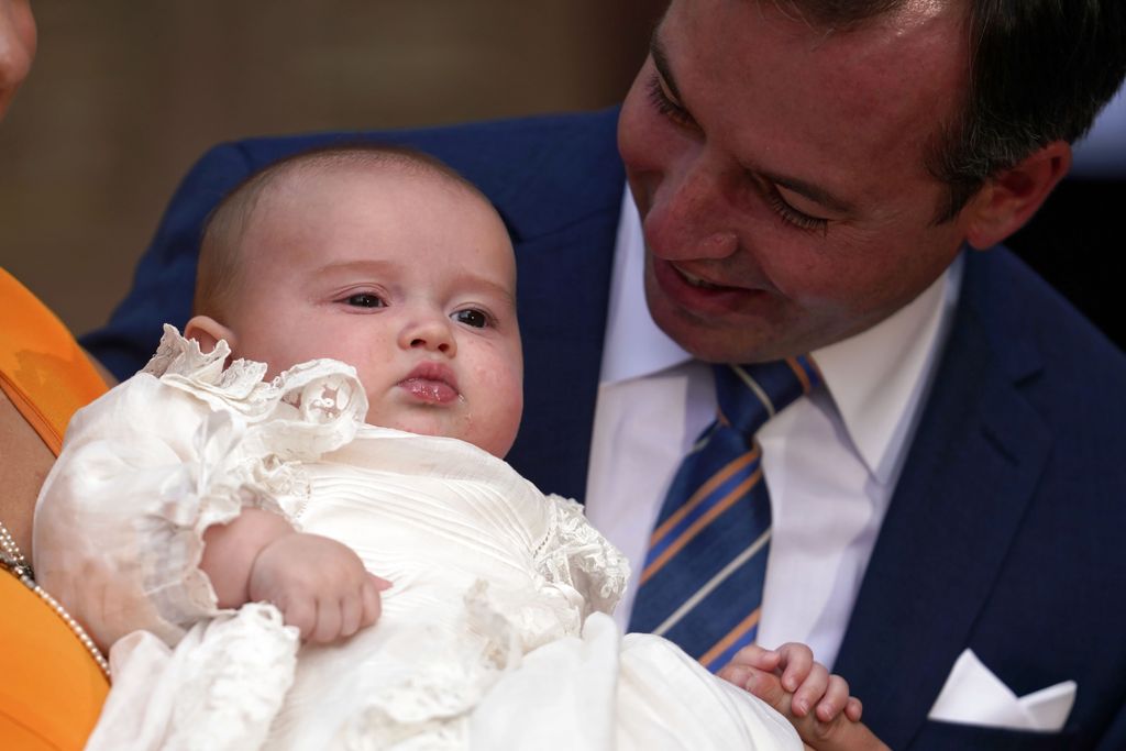 Hereditary Duke Guillaume carrying a baby Prince Charles of Luxembourg