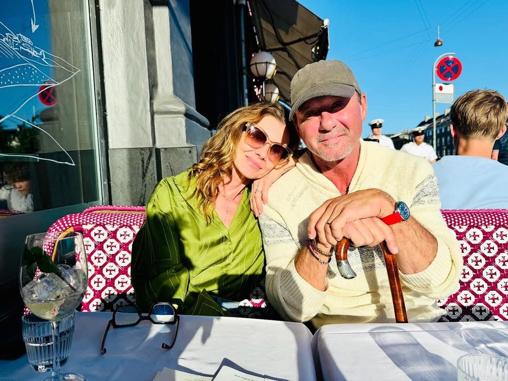 Tim McGraw holds a cane sitting beside his wife Faith Hill in a photo taken in Copenhagen, shared on Instagram