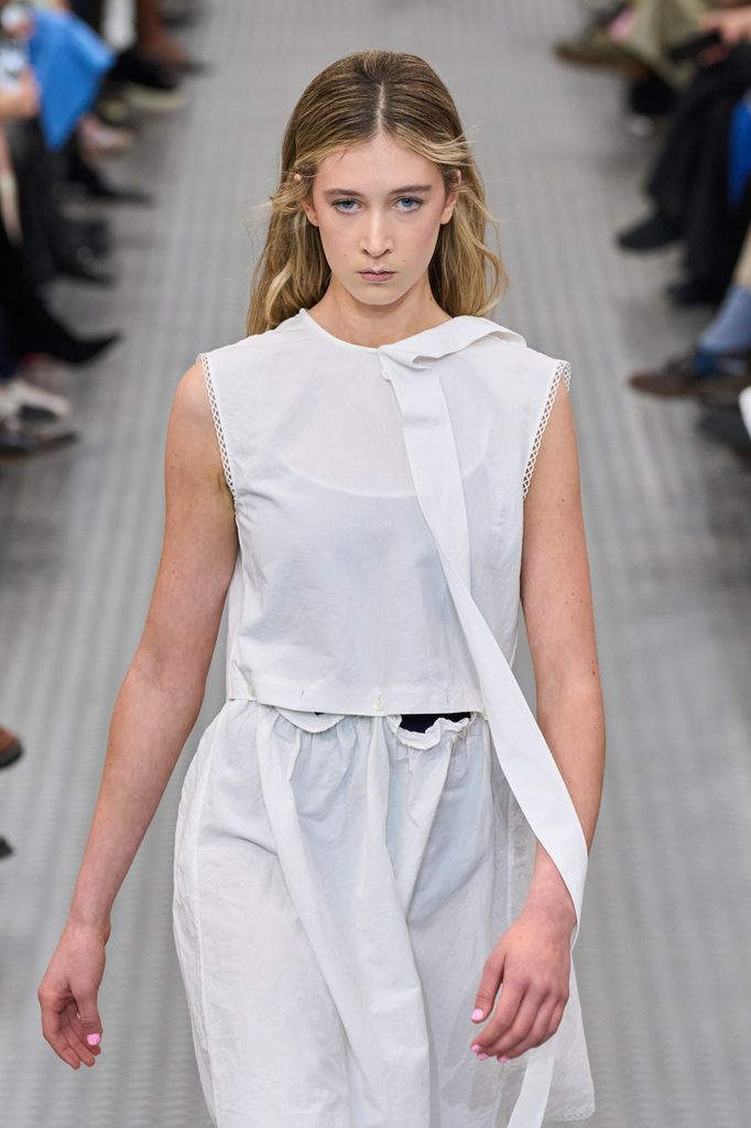 model in all white on the catwalk 