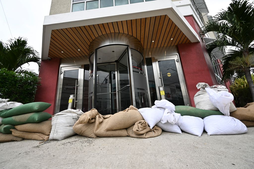 Sandbags are placed at the entrance of the Grace Kennedy building in preparation for the arrival of Hurricane Melissa in downtown Kingston, Jamaica
