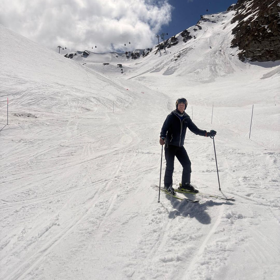 A woman skiing down slopes in the mountains