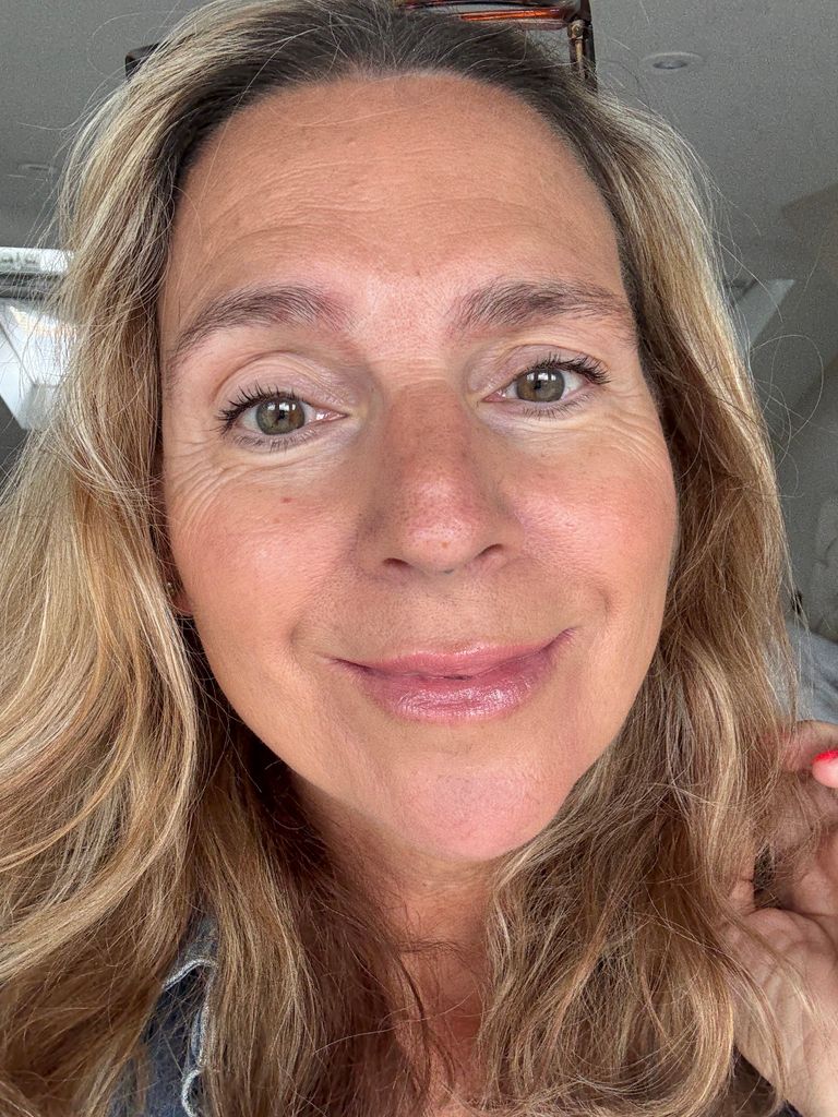 midlife woman with plump pout smiling for the camera