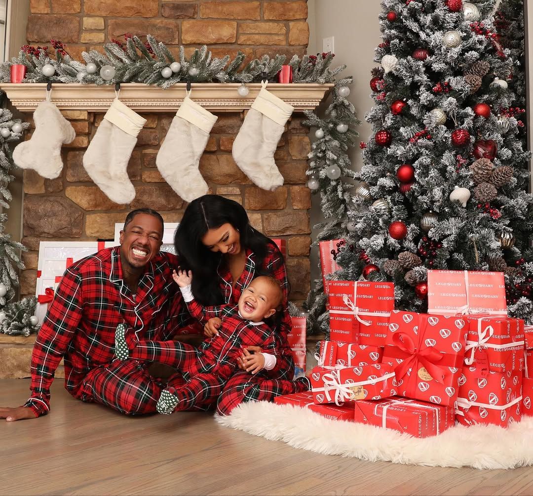 Nick Cannon, Brie Larson and their kid in front of the christmas tree