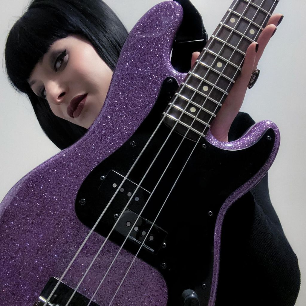 photo of olivia jean holding purple guitar