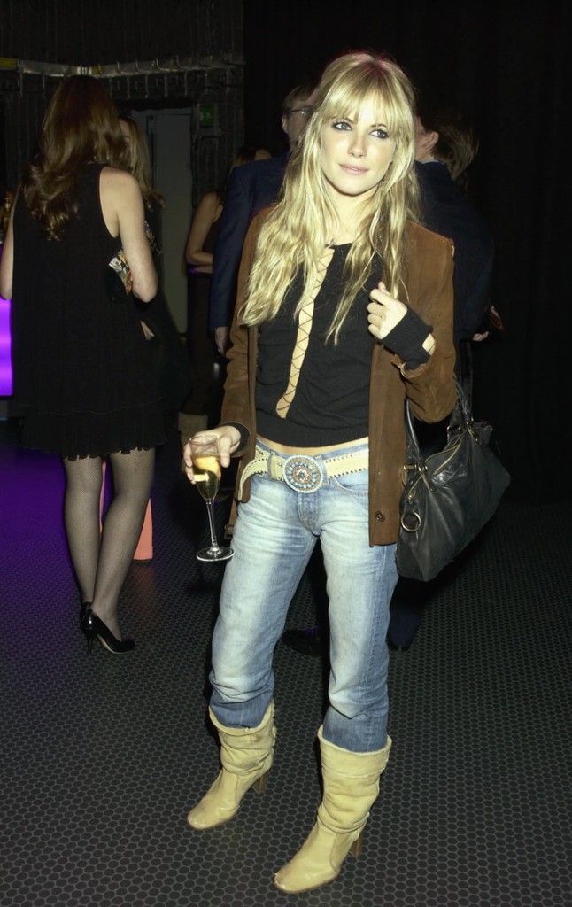 Sienna Miller in cream boots, jeans, and brown blazer