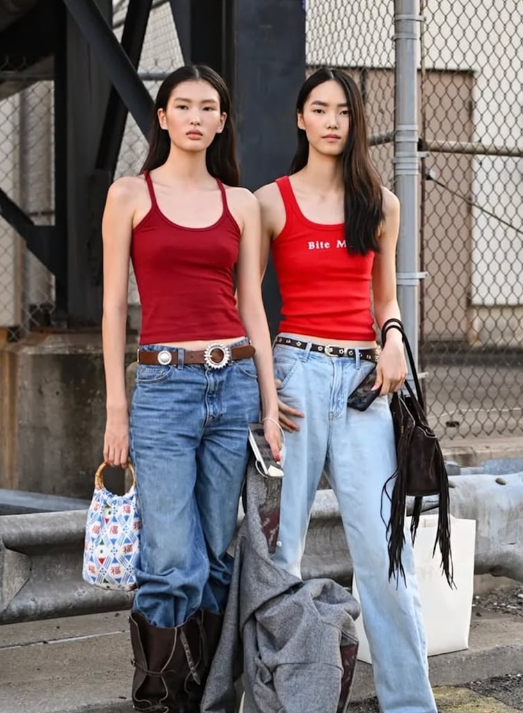 Models wearing red tops, jeans, and brown boots