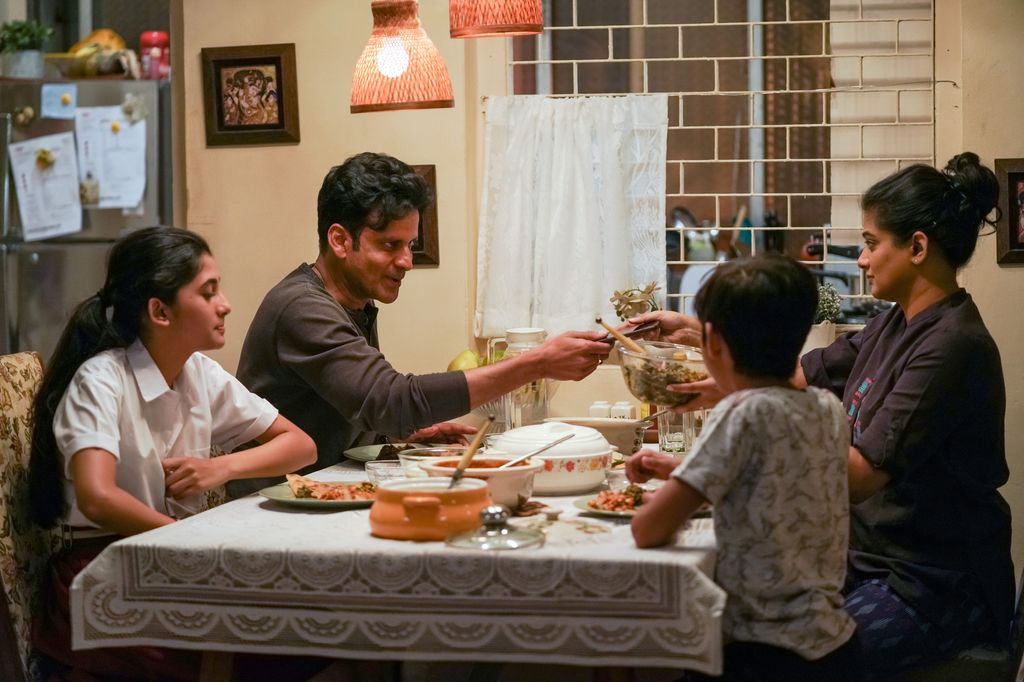 Manoj Bajpayee sitting with two children and his wife in The Family Man