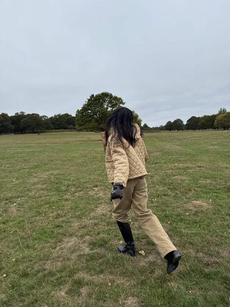 Olivia Pezzente wearing beige trousers, quilted coat and black boots