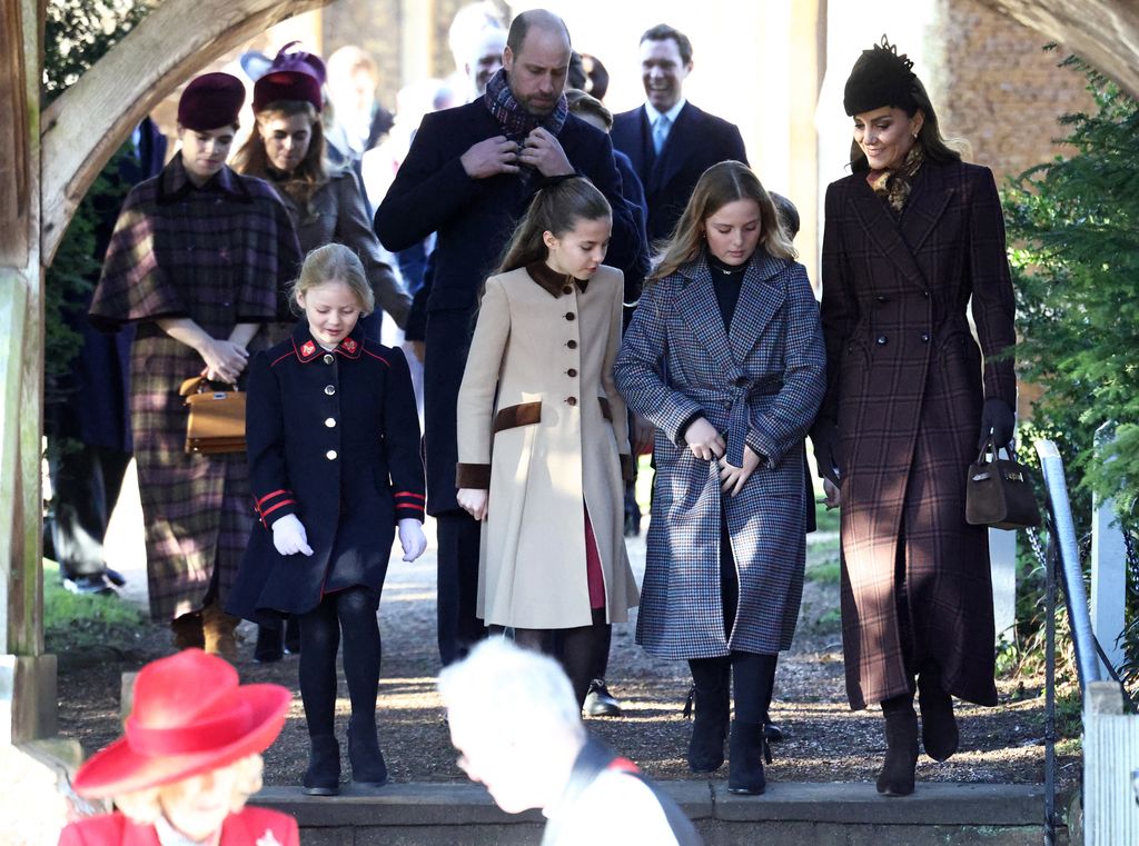 The Princess of Wales and family on Christmas Day 2025 walk out of Sandringham church. Kate wears a long brown coat and matching accessories