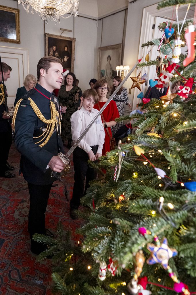Major Ollie Plunket helps Ivan decorate the Christmas tree 