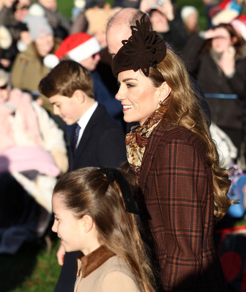 Britain's Catherine, Princess of Wales and her husband Britain's Prince William, Prince of Wales (obscured) arrive with their children Britain's Prince George of Wales, Britain's Prince Louis of Wales (obscured) and Britain's Princess Charlotte of Wales  for the Royal Family's traditional Christmas Day service at St Mary Magdalene Church on the Sandringham Estate in eastern England, on December 25, 2025. (Photo by HENRY NICHOLLS / AFP via Getty Images)