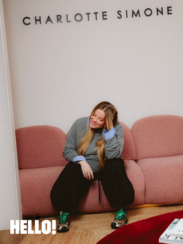 woman sitting on a soft pink sofa