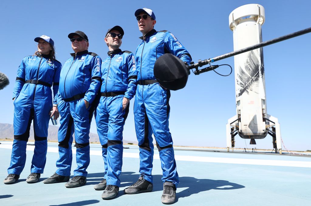 Audrey Powers, William Shatner, Chris Boshuizen and Glen de Vries stand on the landing pad of Blue Origin
