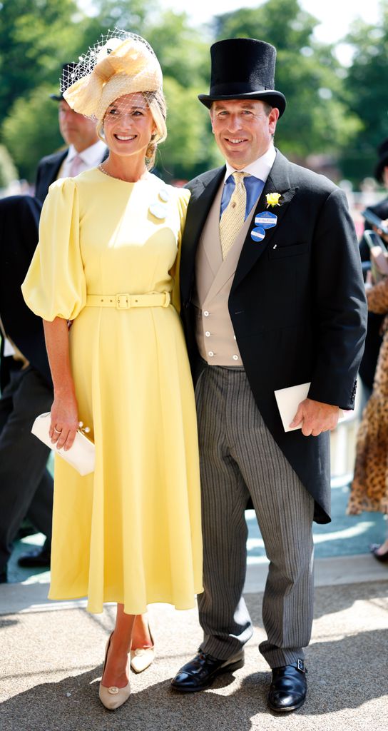 Harriet Sperling in yellow dress and hat and Peter Phillips smiling in suit and top hat