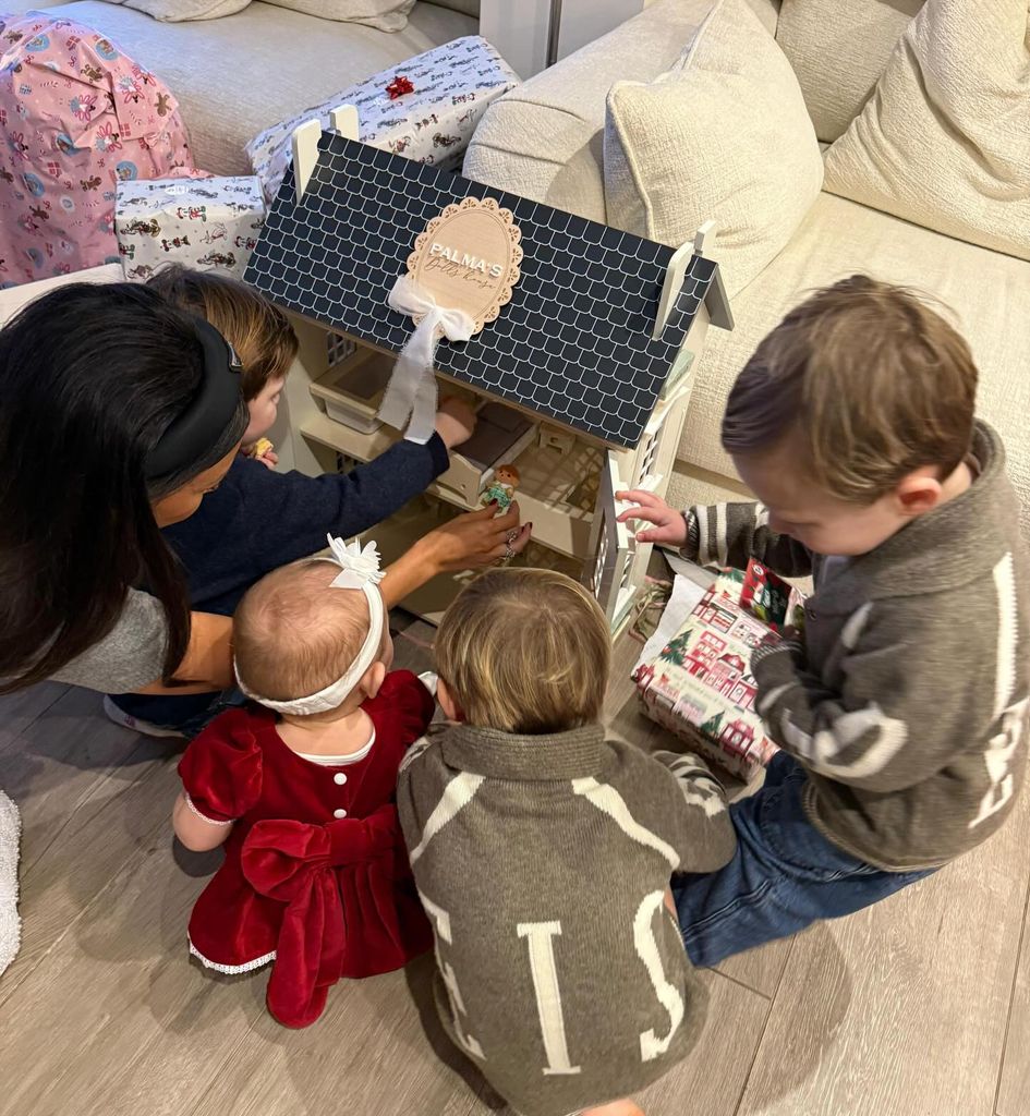 Palma playing with doll house with mum Michelle Keegan and cousins
