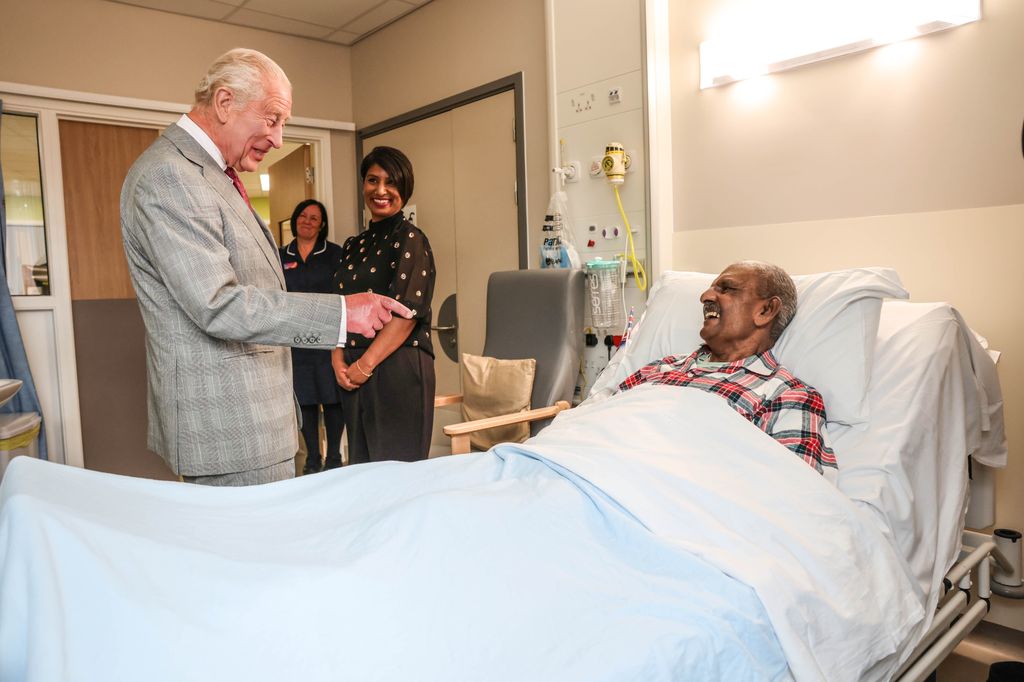 King Charles III talks with Prostate cancer patient Matthew Shinda during a visit to a ward when he officially opened Midland Metropolitan University Hospital 