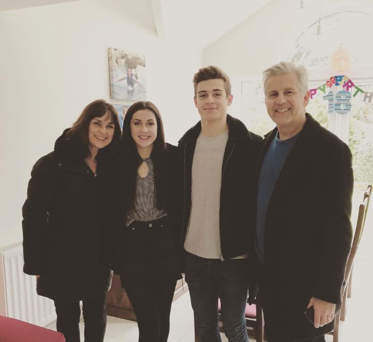 George Clarke standing with his mother, sister and father