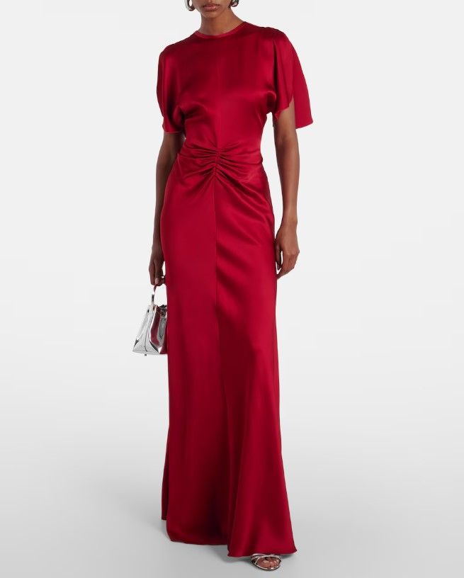 The bridesmaid dresses were known as the 'Caped gathered crêpe satin gown' by Victoria Beckham